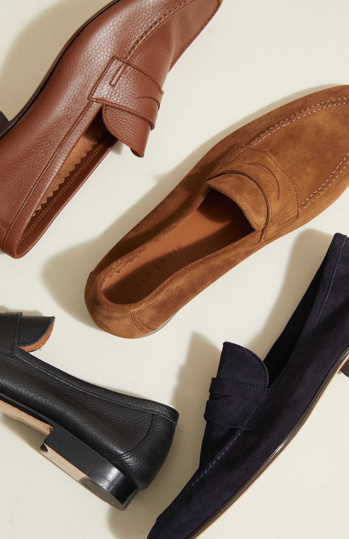 Men's Italian brown leather dress shoe and brown suede dress loafer and black leather and navy suede loafers on the ground