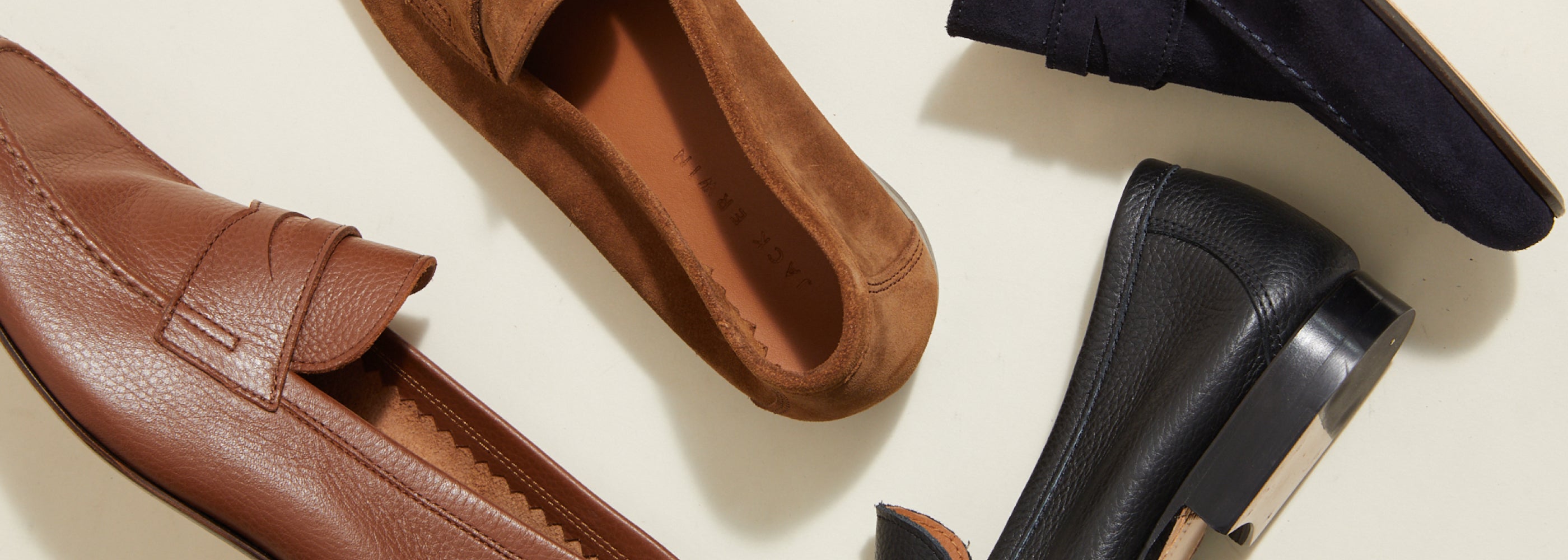 Men's Italian brown leather dress shoe and brown suede dress loafer and black leather and navy suede loafers on the ground