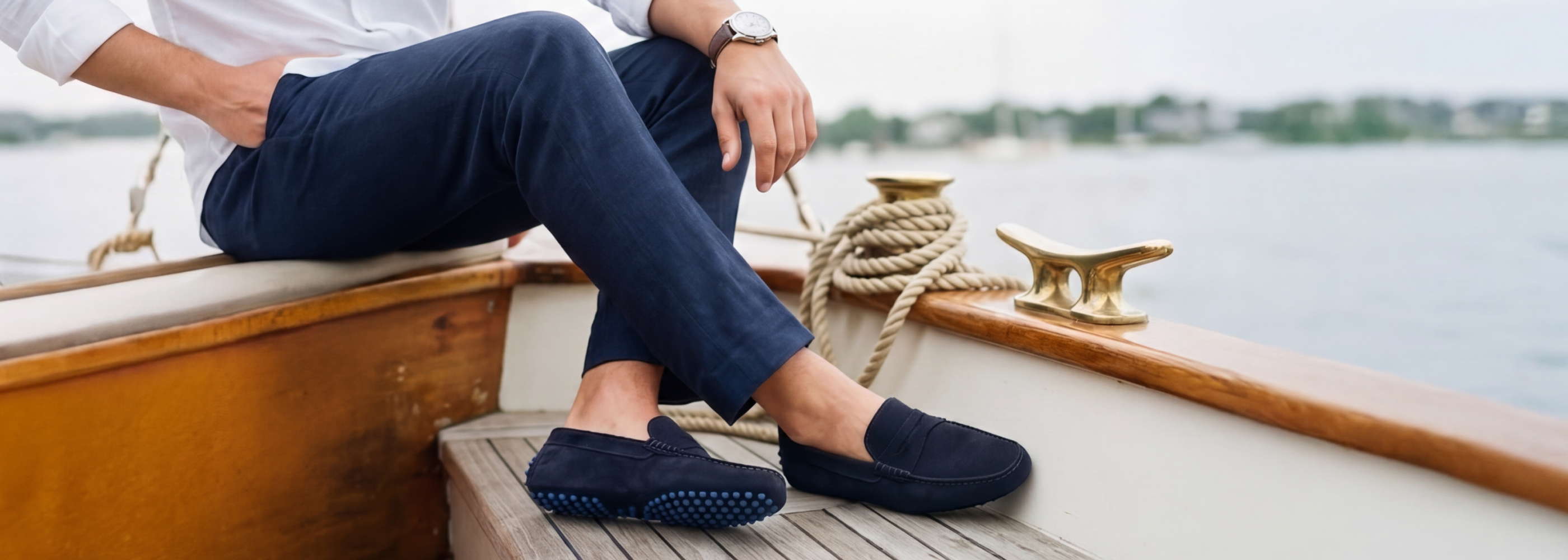 Man sitting on a boat wearing men's European leather driving loafer shoes