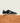 Men's navy European suede lace-up sneaker with beige rubber sole on a wooden platform.