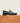 Men's black Italian leather penny loafer dress shoe with black sole.