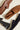 Men's Italian brown leather dress shoe and brown suede dress loafer and black leather and navy suede loafers on the ground