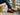 Man sitting on boat wearing men's brown Italian leather driving loafers