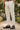 Man standing wearing linen trousers and Men's Italian leather black driving loafers